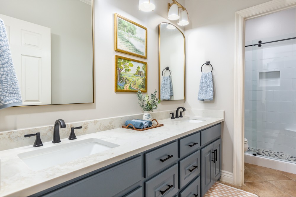 Interior Design_Bathroom Renovation_Bathroom sconces_Bathroom faucets_Gold mirrors_Black faucets_Blue cabinet Interior Design Bathroom